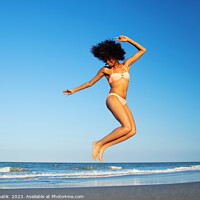 Buy canvas prints of Afro American woman jumping for joy on beach by Spotmatik 