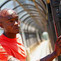 Buy canvas prints of African American male looking though fence after exercising by Spotmatik 
