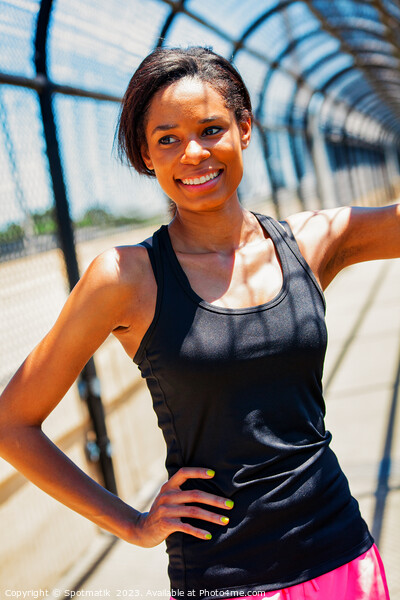 African American female resting on walkway during workout Picture Board by Spotmatik 