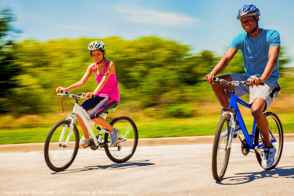 Leisurely cycle ride for young African American couple Picture Board by Spotmatik 