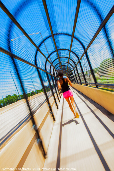 Young Afro American woman running through covered walkway Picture Board by Spotmatik 