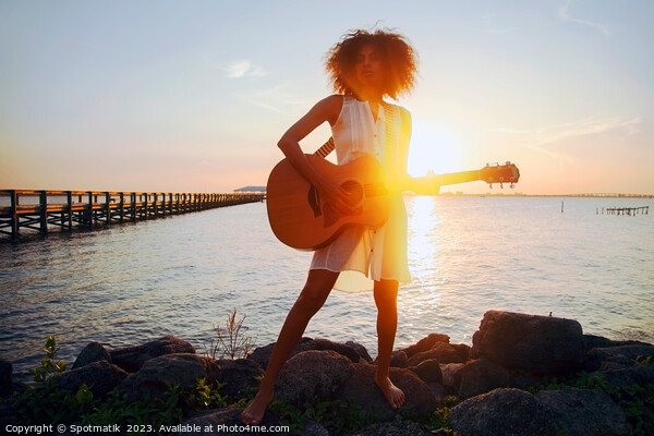 Afro American girl playing guitar with ocean sunset Picture Board by Spotmatik 