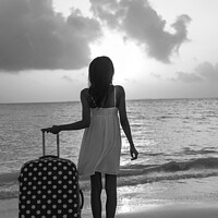 Buy canvas prints of Young woman with suitcase enjoying tropical ocean sunrise by Spotmatik 