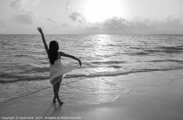 Asian girl with arms outstretched by the ocean Picture Board by Spotmatik 