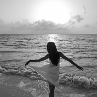 Buy canvas prints of Asian girl with arms outstretched by the ocean by Spotmatik 