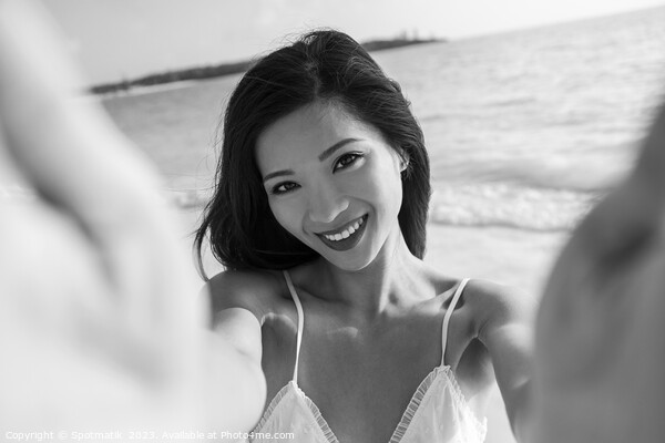 Outdoor portrait of smiling Asian female reaching out Picture Board by Spotmatik 