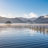 Buy canvas prints of Derwent Water in Winter misty sky and sunrays shin by Julian Carnell
