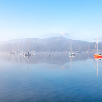 Buy canvas prints of Sailing Boats on Windermere on a winters morning with mist and sun glow by Julian Carnell
