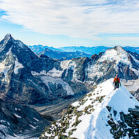 Buy canvas prints of Alpinist on Dent Blanche with Matterhorn in the background by Julian Carnell