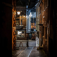 Buy canvas prints of Bricks and cobbles along the street by Ian Mortlock