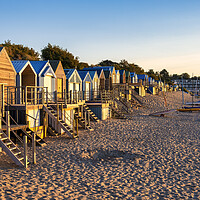 Buy canvas prints of Quirky Wooden Beach Huts at Sunrise by Tim Hill
