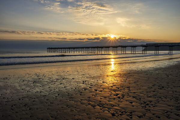 Sun star over Saltburn Pier Picture Board by Tim Hill