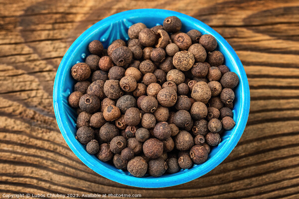 Allspice spice in a small bowl on the table Picture Board by Lubos Chlubny