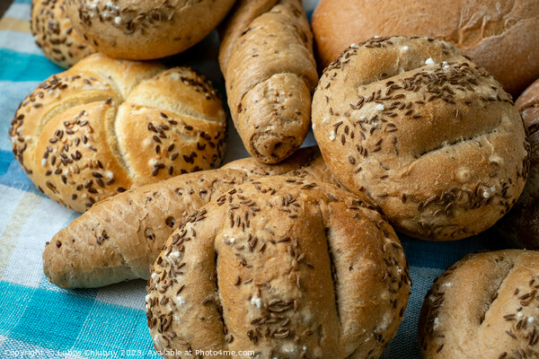 Heap of various bread rolls sprinkled with salt, caraway and sesame. Fresh rustic bread from leavened dough. Assortment of freshly of bakery products Picture Board by Lubos Chlubny