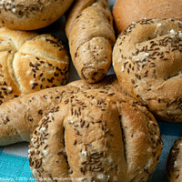 Buy canvas prints of Heap of various bread rolls sprinkled with salt, caraway and sesame. Fresh rustic bread from leavened dough. Assortment of freshly of bakery products by Lubos Chlubny