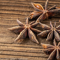Buy canvas prints of Dried star anise spice on vintage wooden board by Lubos Chlubny