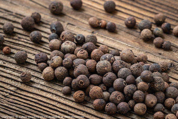 Allspice spice on wooden table Picture Board by Lubos Chlubny