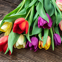 Buy canvas prints of Colorful tulips on wooden table by Lubos Chlubny