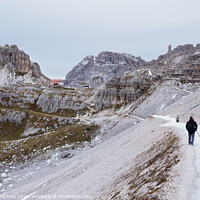 Buy canvas prints of Tourist at Tre Cime di Lavaredo track on winter season. National Park Tre Cime di Lavaredo, Dolomite Alps mountains, Trentino Alto Adige region, Dolomites, Italy by Lubos Chlubny