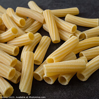 Buy canvas prints of Raw italian penne rigate pasta isolated on black background by Lubos Chlubny