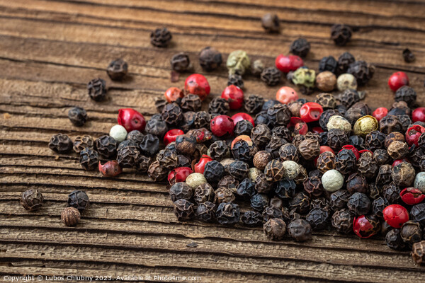 Peppercorns on dark rustic wooden background. Mix of different peppers Picture Board by Lubos Chlubny
