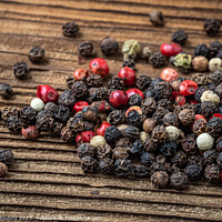 Buy canvas prints of Peppercorns on dark rustic wooden background. Mix of different peppers by Lubos Chlubny