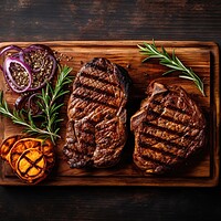 Buy canvas prints of Grilled meat barbecue steak on wooden cutting board with rosemary and copy space. Top view. by Lubos Chlubny