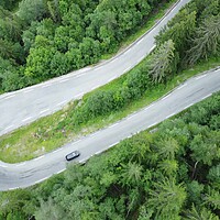 Buy canvas prints of Aerial view of a winding road and forest in Norway. Picturesque mountain road by Irena Chlubna