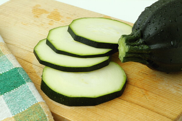 Close up of sliced zucchini on wooden cutting board Picture Board by Irena Chlubna