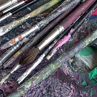 Buy canvas prints of Used brushes on an artist's palette of colorful oil paint by Irena Chlubna