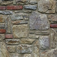 Buy canvas prints of Masonry wall of multicolored stones or blocks by Irena Chlubna