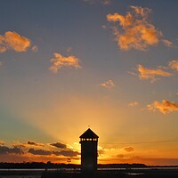 Buy canvas prints of Brightlingsea sunsetting behind Batemans Tower in full colour  by Tony lopez