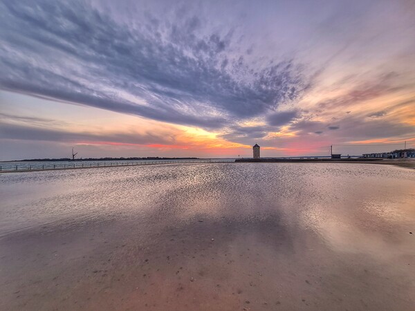 Sunset cloudscape and colours over the Brightlingsea tidal pool and Batemans Tower.  Picture Board by Tony lopez