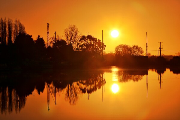 Sunrise reflections over St Osyth Boatyard in essex  Picture Board by Tony lopez