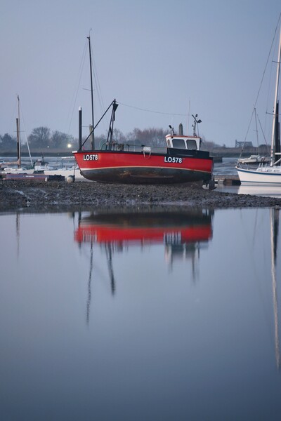 Low tide over Brightlingsea Harbour in reflection  Picture Board by Tony lopez