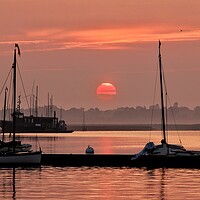 Buy canvas prints of Red sunrise over Brightlingsea Harbour  by Tony lopez