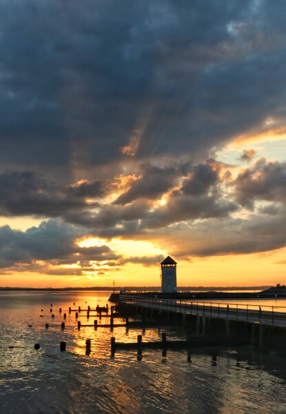 Sunset over Batemans tower in Brightlingsea essex  Picture Board by Tony lopez
