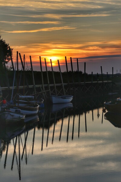 Sunset reflections over Blakeney Quay Norfolk  Picture Board by Tony lopez
