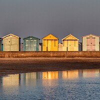 Buy canvas prints of Beach huts basking in a Brightlingsea  Sunset  by Tony lopez