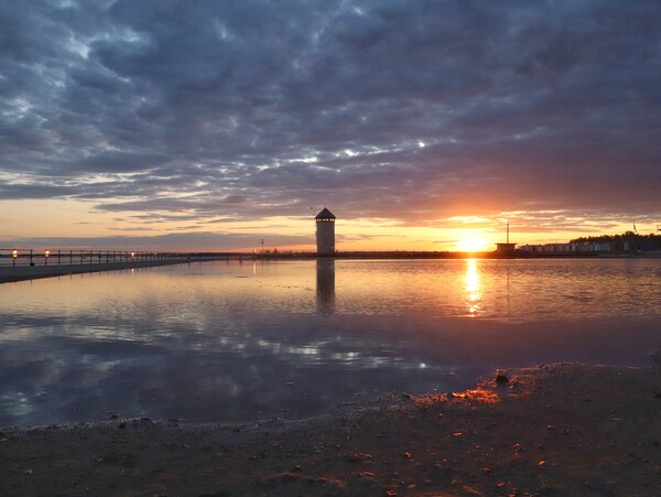 Sun setting over Batemans Tower in Brightlingsea in full reflections  Picture Board by Tony lopez