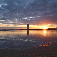 Buy canvas prints of Sun setting over Batemans Tower in Brightlingsea in full reflections  by Tony lopez