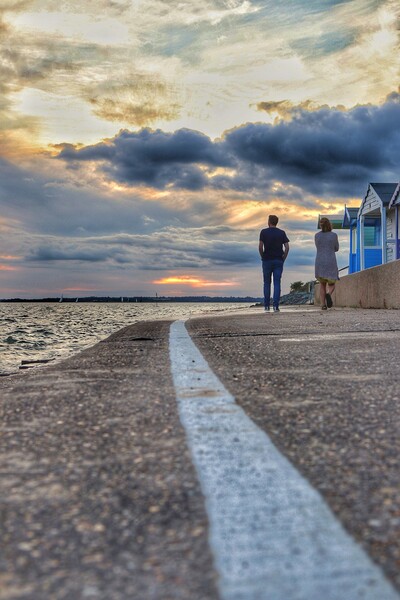 Walking into the  sunset colours across the river Colne In  Brightlingsea.  Picture Board by Tony lopez