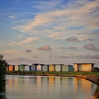 Buy canvas prints of Sunrise over th beach huts around the Boating lake in Brightlingsea  by Tony lopez