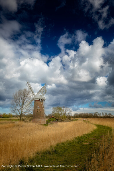 The clouds in the Sky towering over Hardley Mill wind pump Picture Board by Derek Griffin