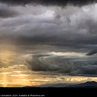 Buy canvas prints of Sunlight Breaking Through a Stormy Scottish Sky by Ian Donaldson