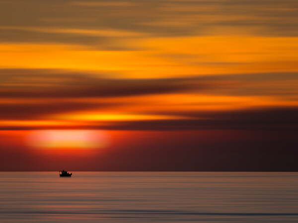 Boat on the horizon with sunrise (Horizon Dreams) Picture Board by Martyn Large