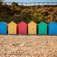 Buy canvas prints of Colourful beach huts at Llanbedrog Beach by David Macdiarmid