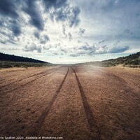 Buy canvas prints of Tracks in the sand across a beach by Chris Spalton