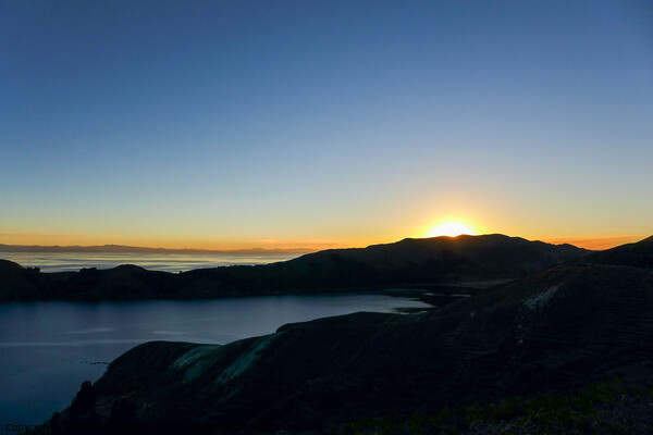 Isla del Sol sunset behind mountains on Lake Titicaca Picture Board by Madeleine Deaton