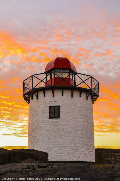 Bury port lighthouse at sunset Picture Board by Rick Pearce